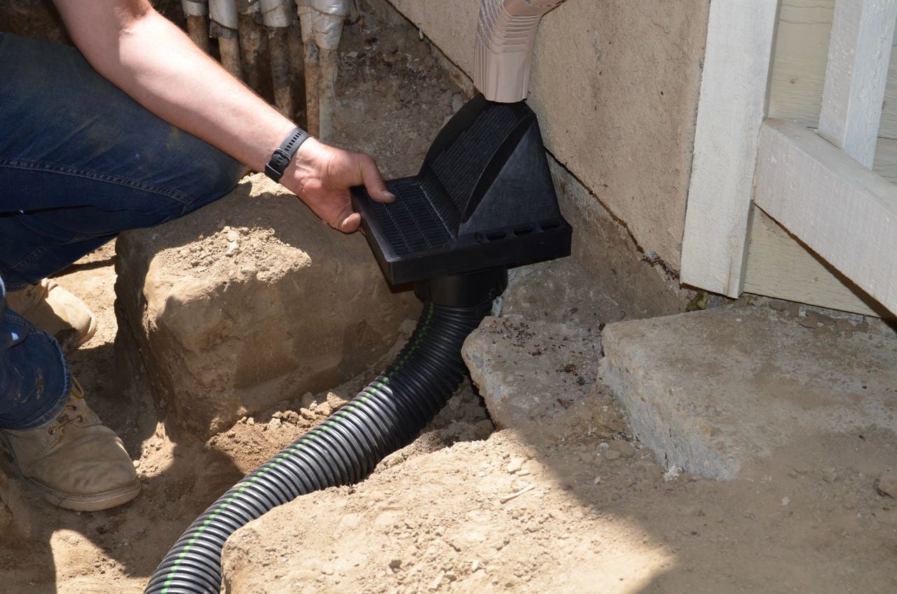 Corrugated flexible drainage pipe under NDS Downspout Defender