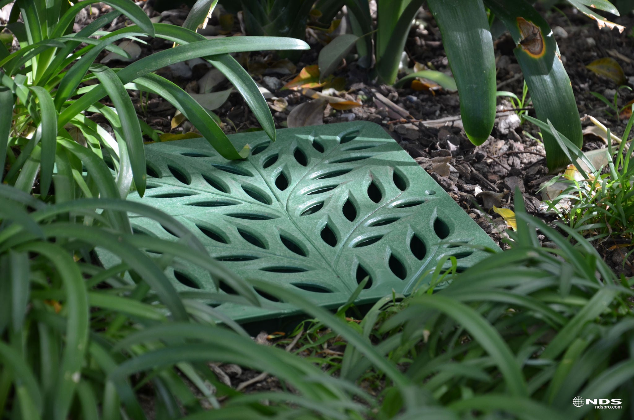 Wave Grate Installed in landscape bed