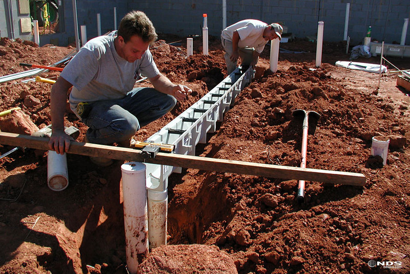 Contractors installing drainage